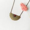 Handmade-bronze-necklace-for-women-with-a-red-gemstone-pendant-made-in-France