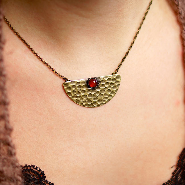 Handmade-bronze-necklace-for-women-with-a-dark-red-gemstone-pendant-made-in-France