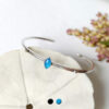 Customed-handmade-silver-adjustable-bangle-bracelet-for-women-with-a-blue-gemstone-made-in-France
